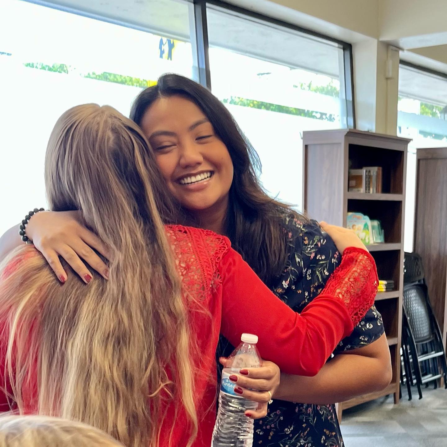 Two women sharing a warm hug at Maluhia Baptist Church