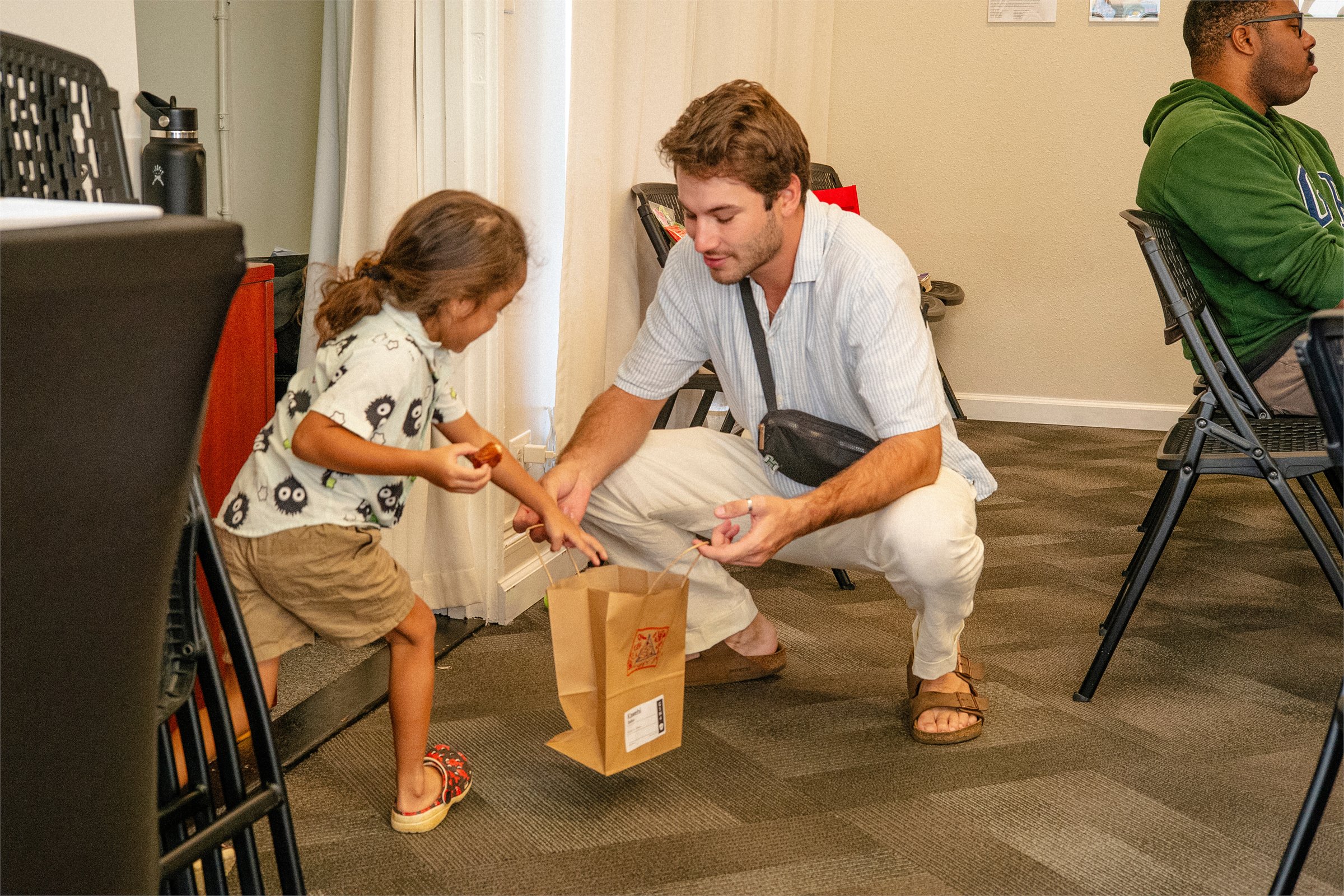 A child receiving a welcome gift at Maluhia Baptist Church