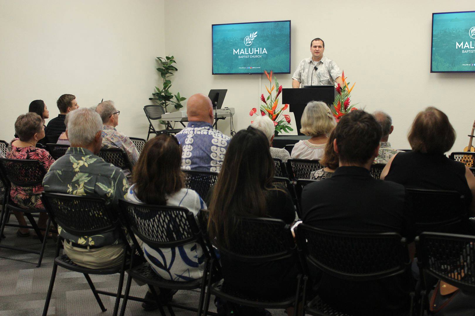 Pastor Travis preaching to the Maluhia Baptist Church congregation