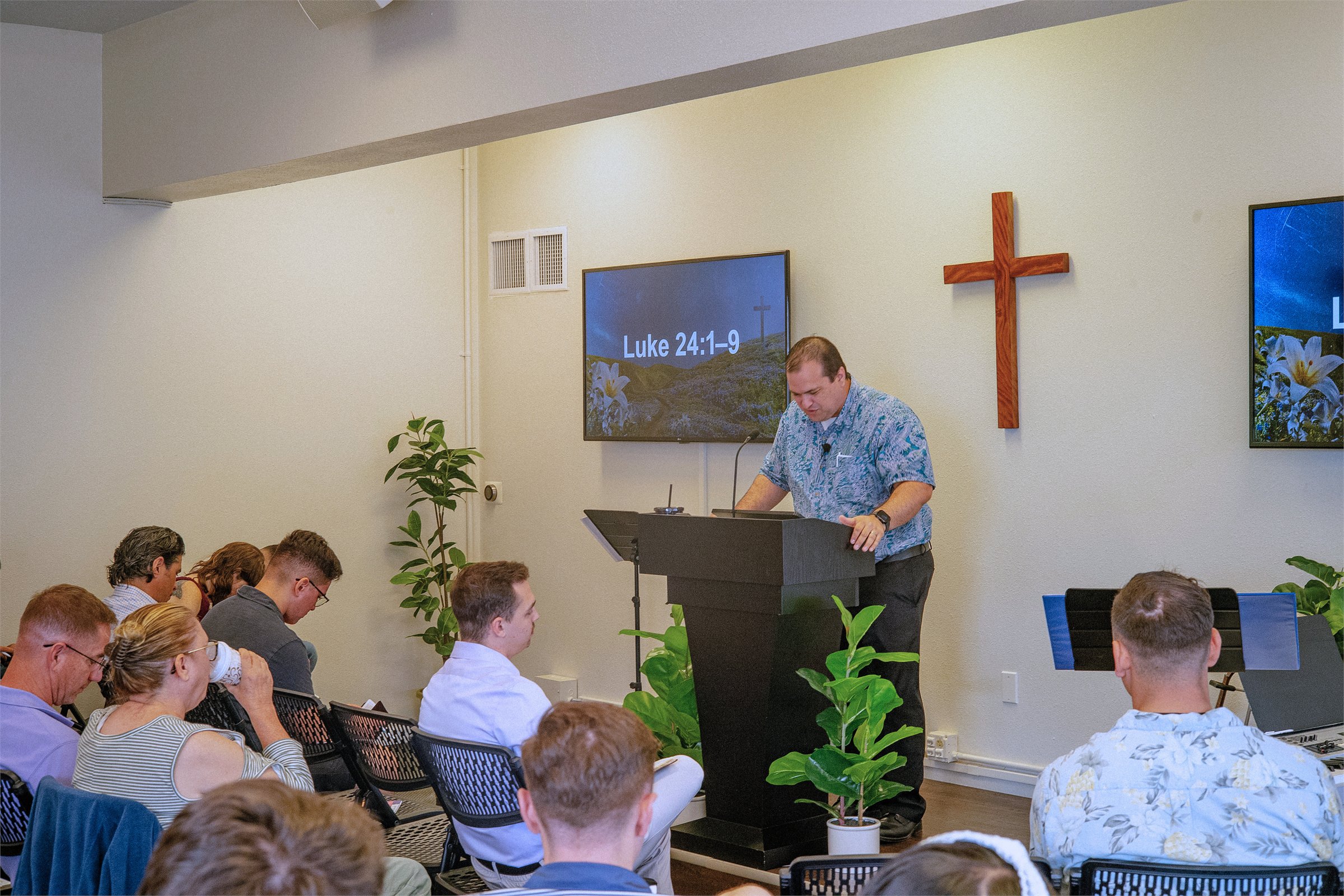 Pastor Travis preaching from the Bible during a Maluhia worship service