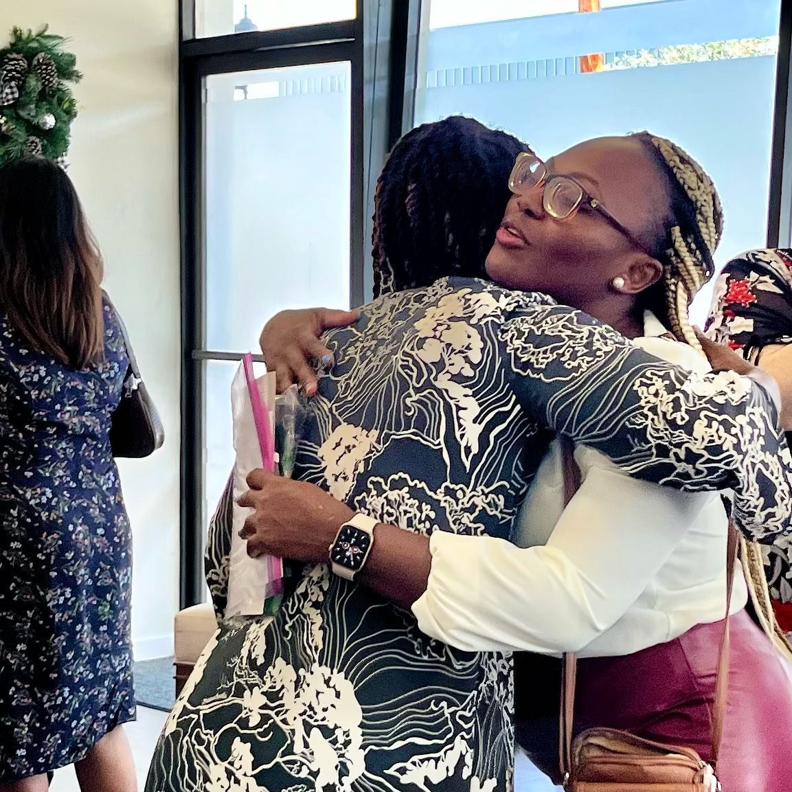 Two women sharing a warm welcome at Maluhia Baptist Church